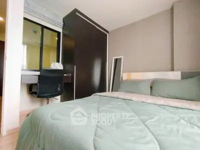 Modern bedroom with cozy bedding and study area in stylish apartment