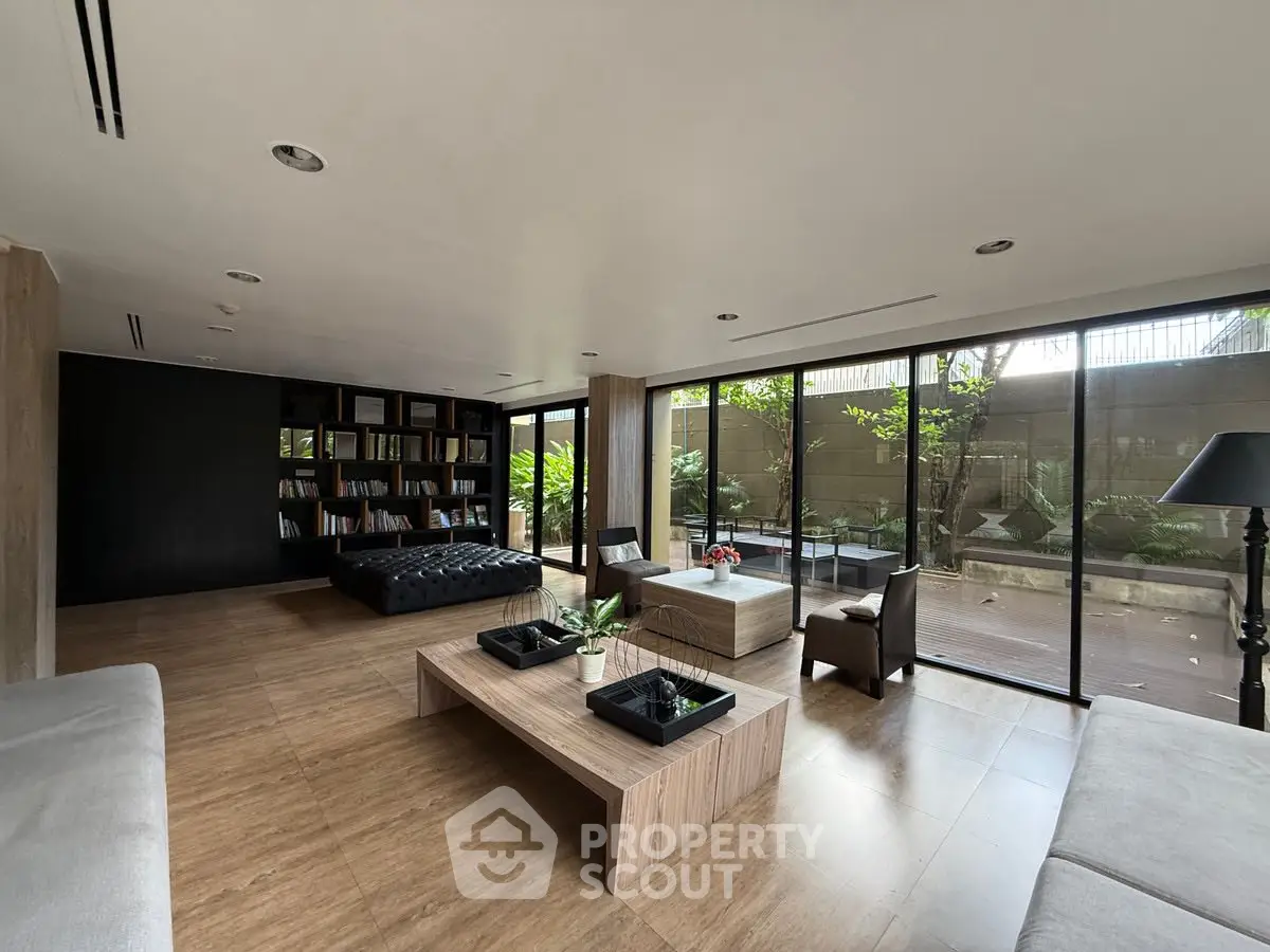 Spacious modern living room with floor-to-ceiling windows and elegant decor