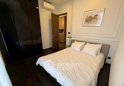 Cozy bedroom with modern decor and elegant lighting in a stylish apartment.
