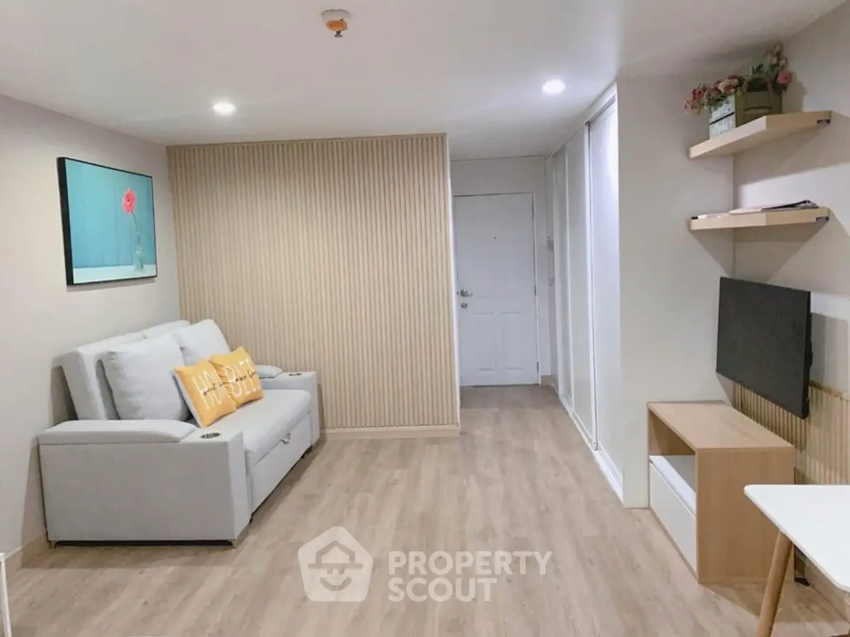 Modern living room with stylish decor and cozy seating in a contemporary apartment.