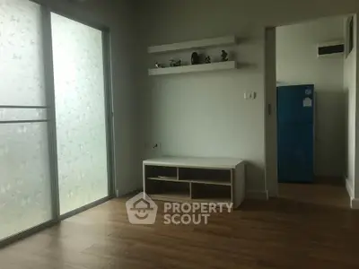 Modern living room with wooden flooring and frosted glass door