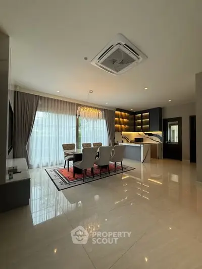 Luxurious open-layout living room with elegant dining area and modern lighting