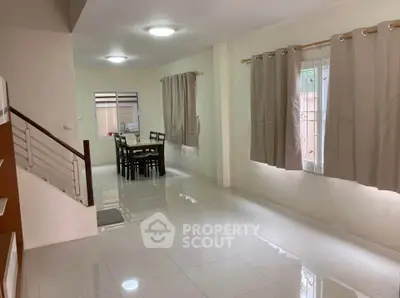 Spacious open-plan living and dining area with modern design and natural light.