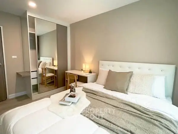 Cozy bedroom with modern decor and soft lighting, featuring a comfortable bed and stylish furniture.