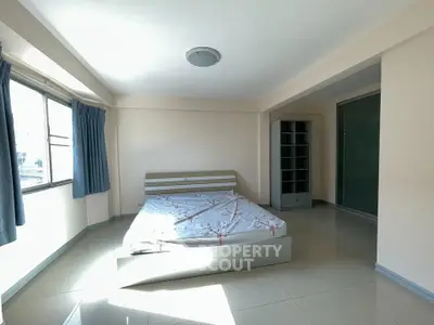 Spacious bedroom with large windows and modern design