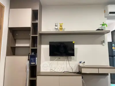 Modern living room with wall-mounted TV and sleek storage solutions