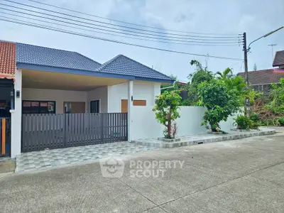 Charming single-story home with modern design and spacious driveway in a serene neighborhood.