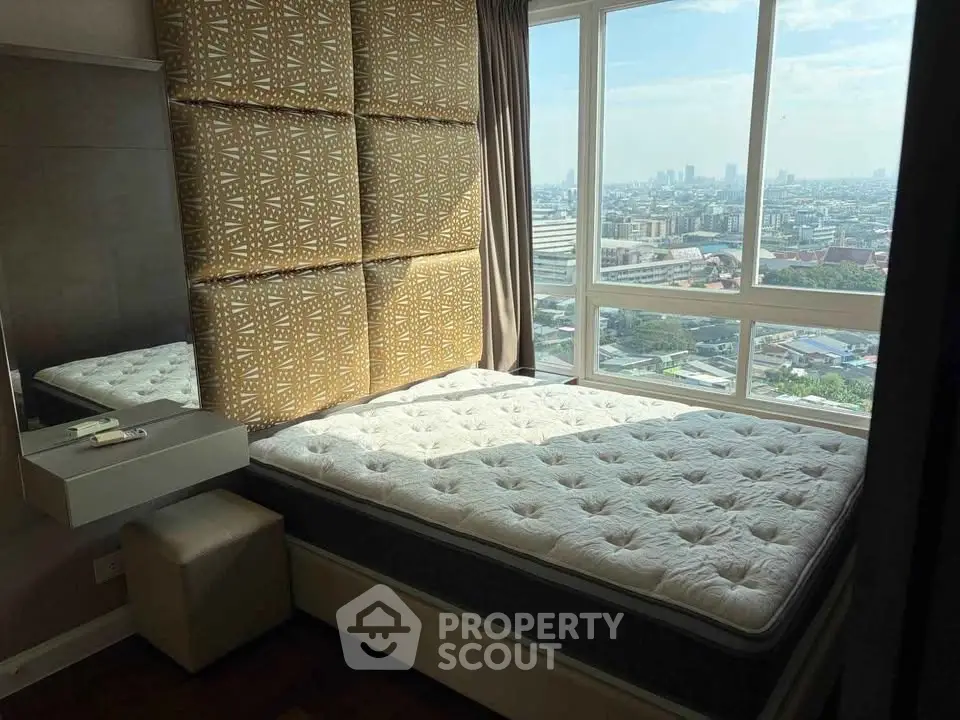 Luxurious bedroom with stunning city view and modern decor in high-rise apartment.