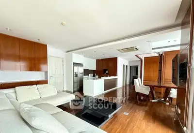Spacious modern living room with open kitchen and elegant wooden flooring