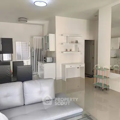 Modern open-plan living room with sleek furniture and minimalist decor