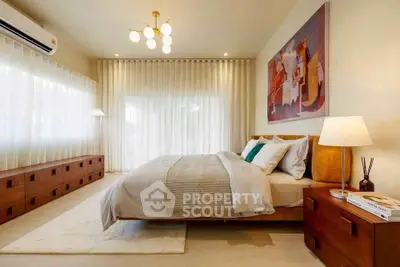 Luxurious bedroom with modern decor and ample natural light