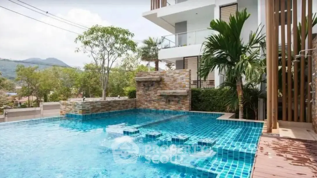 Luxurious modern building with stunning pool and scenic mountain view.
