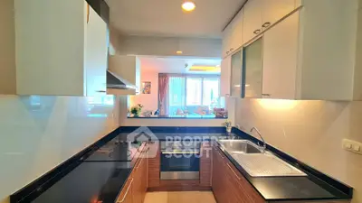 Modern kitchen with sleek black countertops and open layout design