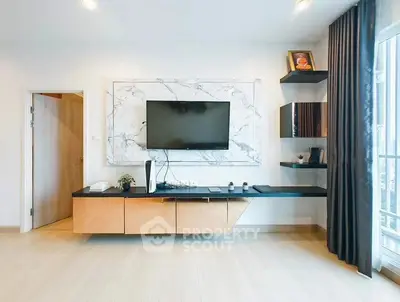 Modern living room with wall-mounted TV and stylish shelving