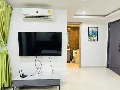 Modern living room with wall-mounted TV and air conditioning in a stylish apartment.