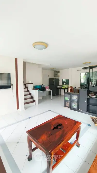 Spacious living room with modern furniture and open layout, perfect for family gatherings.