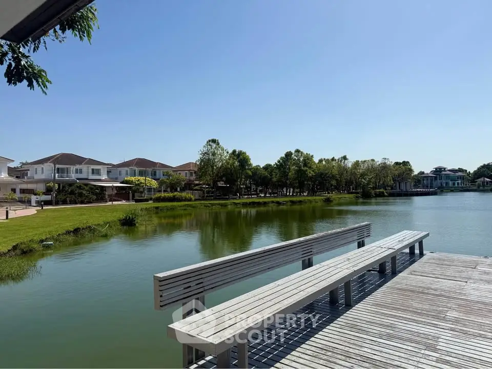 Scenic waterfront view with modern homes and lush greenery, perfect for serene living.