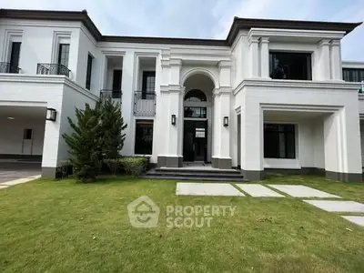 Luxurious modern mansion with elegant architecture and lush green lawn, perfect for upscale living.