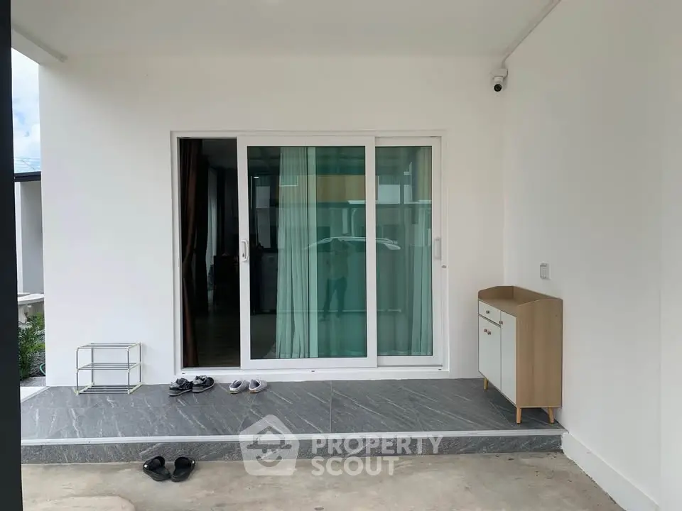 Modern entrance with sliding glass doors and minimalist decor