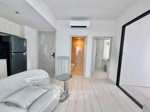 Modern apartment interior with sleek furniture and open layout, featuring a stylish living area and kitchen.