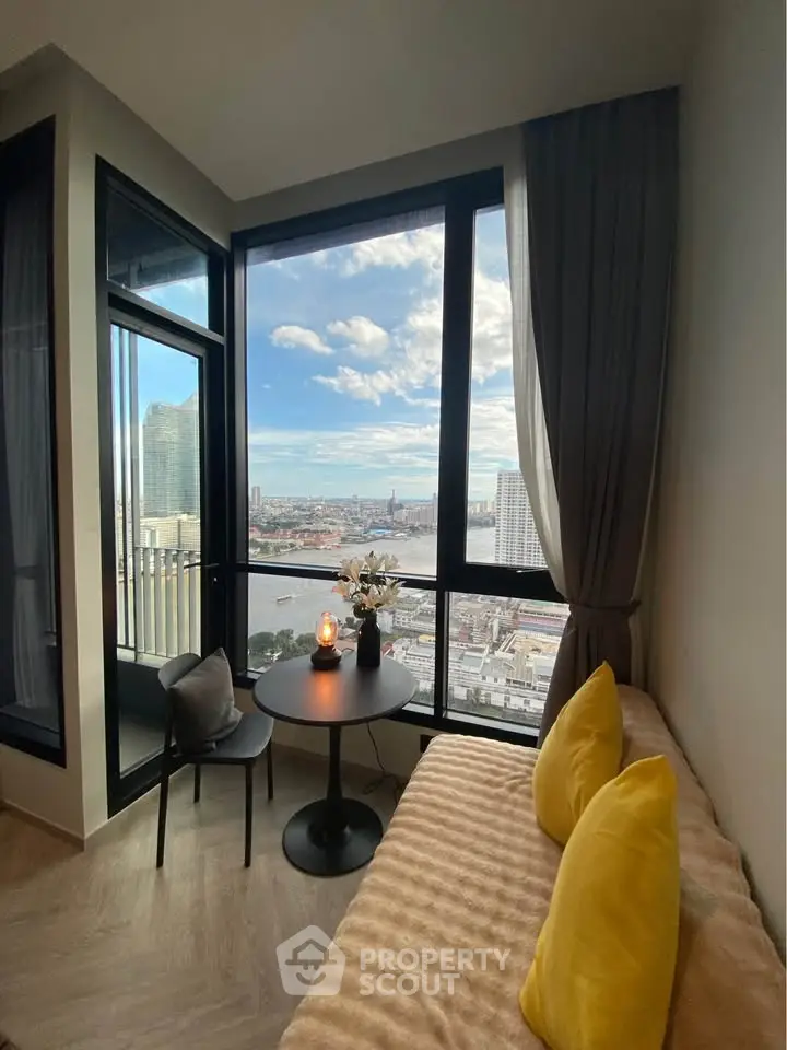 Stunning high-rise apartment with panoramic city view and cozy seating area.