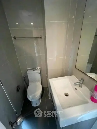 Compact modern bathroom with sleek fixtures and neutral tiles, ideal for urban living spaces.