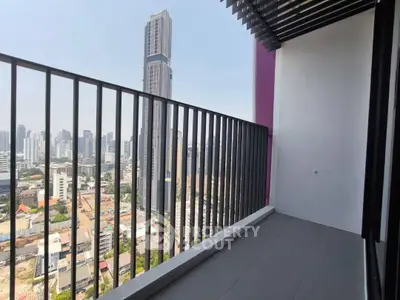 Spacious balcony with stunning city skyline view in modern high-rise apartment.