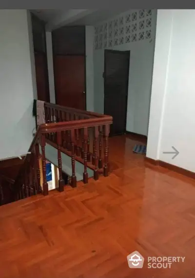 Spacious wooden staircase with elegant railing in a modern home interior