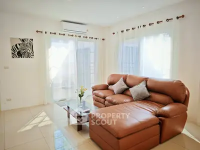 Spacious living room with leather sectional and natural light