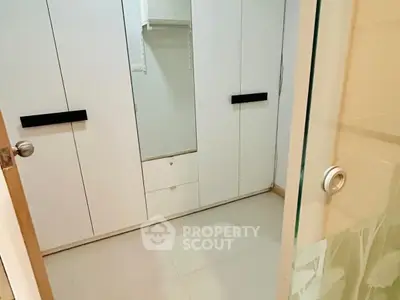 Spacious walk-in closet with modern design and ample storage space.