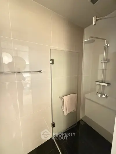 Modern bathroom with glass shower enclosure and sleek fixtures
