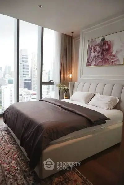 Luxurious bedroom with city view and elegant decor in high-rise apartment