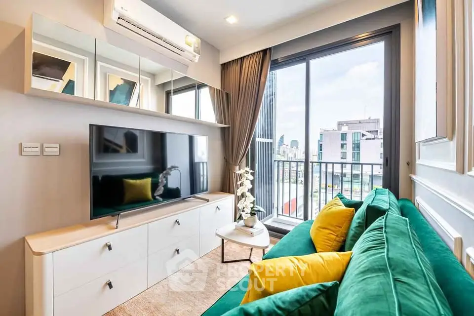 Modern living room with green sofa, large TV, and city view balcony in a stylish apartment.