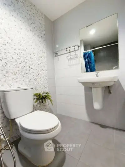 Modern bathroom with sleek fixtures and stylish tile design.