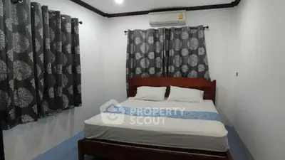 Cozy bedroom with air conditioning and stylish curtains, perfect for restful nights.
