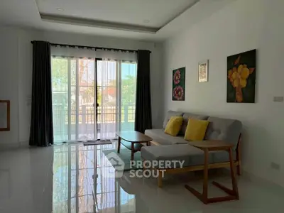 Spacious living room with modern decor and large window view