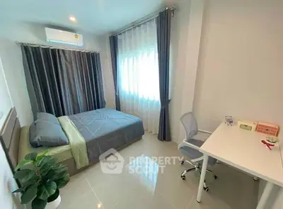 Modern bedroom with study area, featuring sleek design and natural light, perfect for urban living.
