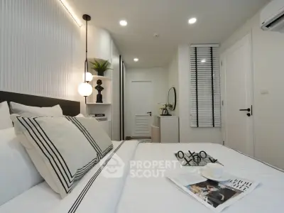 Modern bedroom with stylish decor and cozy ambiance, featuring elegant lighting and contemporary furnishings.