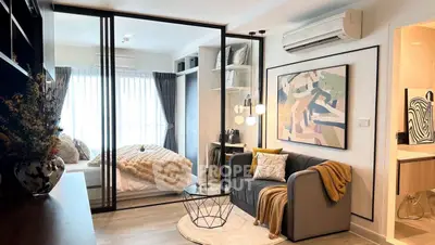 Modern studio apartment with stylish decor and glass partitioned bedroom.