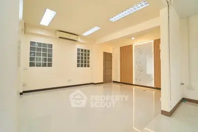 Spacious modern living room with marble accent wall and sleek lighting