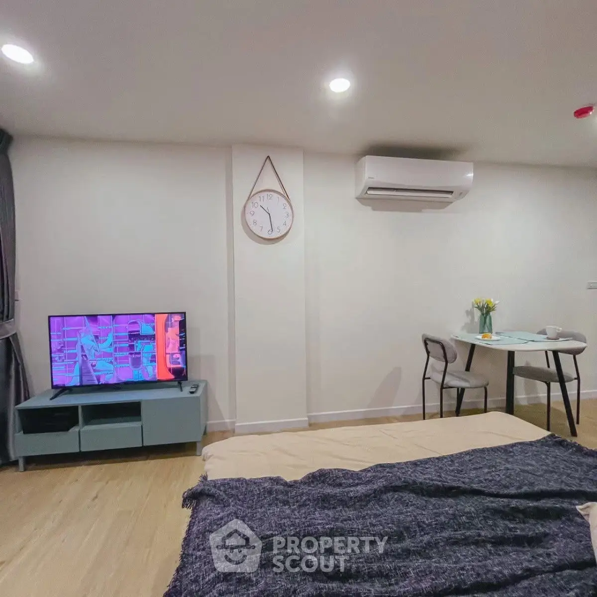 Cozy modern living space with TV, dining area, and air conditioning