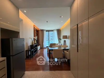 Spacious modern living room with elegant decor and large windows offering city views.