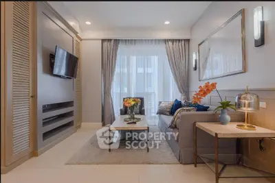 Elegant living room with modern decor, cozy seating, and natural light from large windows.