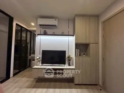 Modern living room with sleek TV setup and stylish wooden cabinetry.