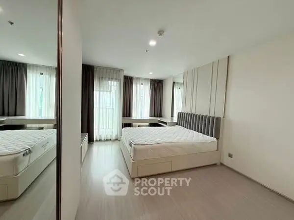 Spacious modern bedroom with large windows and stylish decor