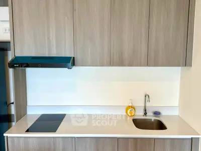 Modern kitchen with sleek cabinetry and built-in stovetop, perfect for contemporary living.