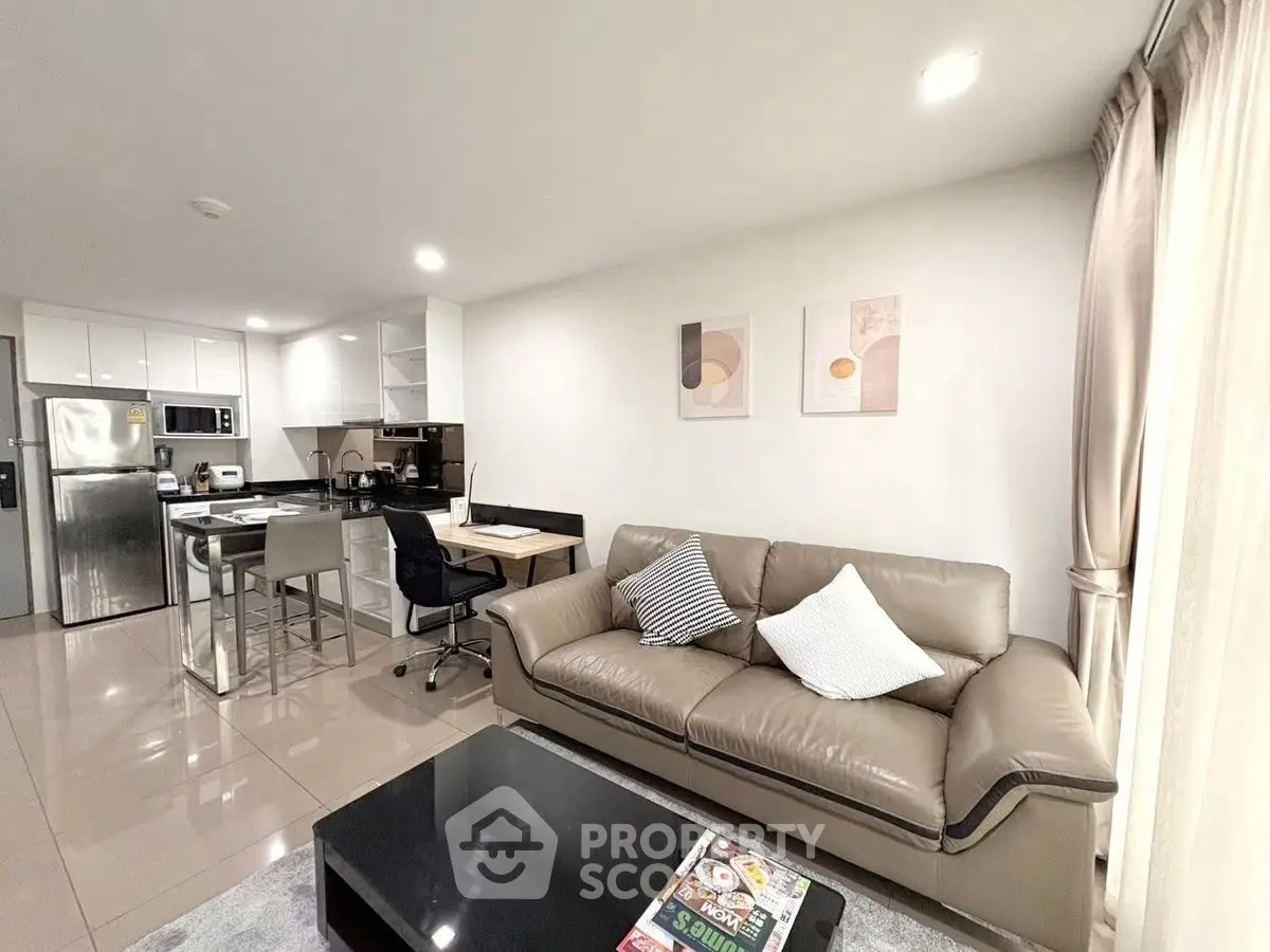 Modern open-layout living room with sleek kitchen and stylish decor