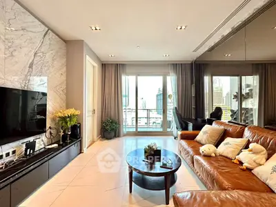 Luxurious living room with marble accents and city view, featuring a stylish leather sofa and modern decor.