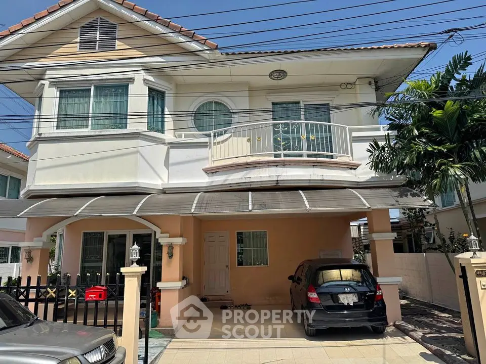 Charming two-story house with carport and balcony in a serene neighborhood.