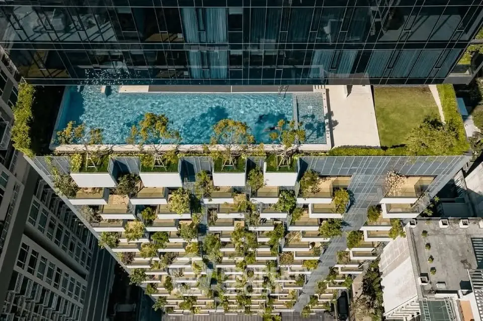 Stunning rooftop pool with lush greenery on modern high-rise building